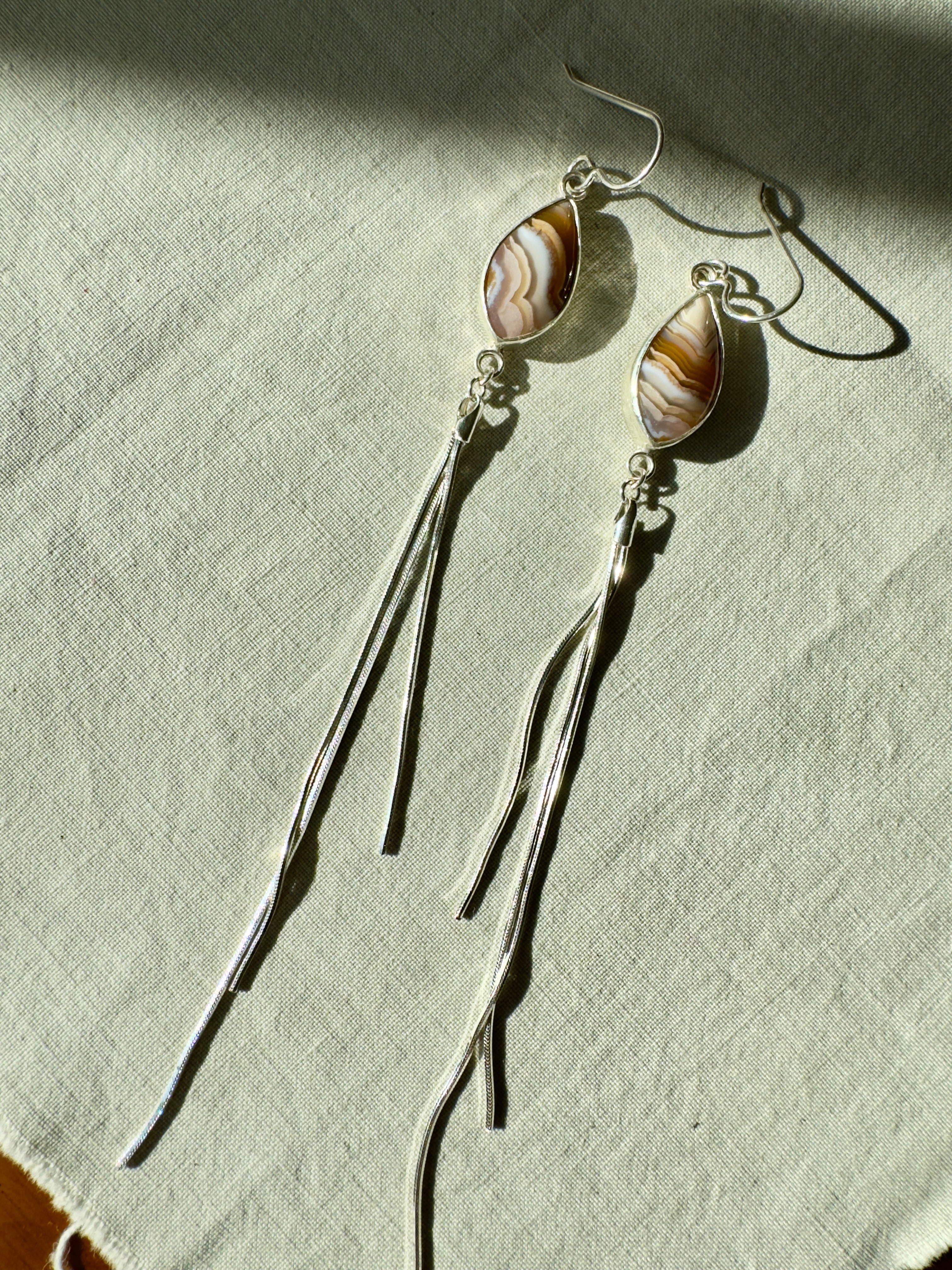 Pretty pinks and nudes Agua Nueva on sterling silver with sterling silver snake chain dangles. One of a kind, handmade pair.