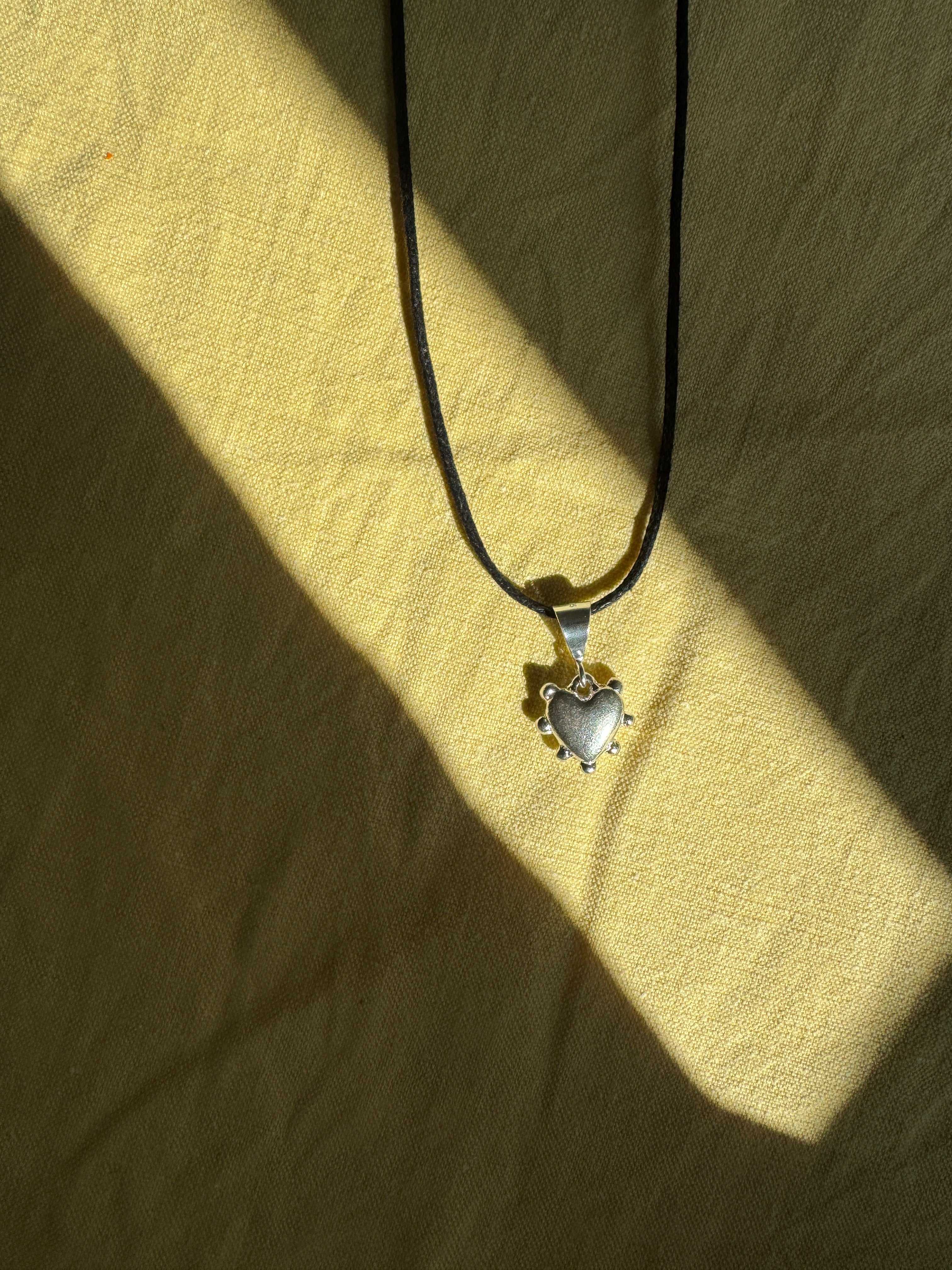 Thick sterling silver heart bordered with dots. This heart is a casting from an original mold that I created out of wax.