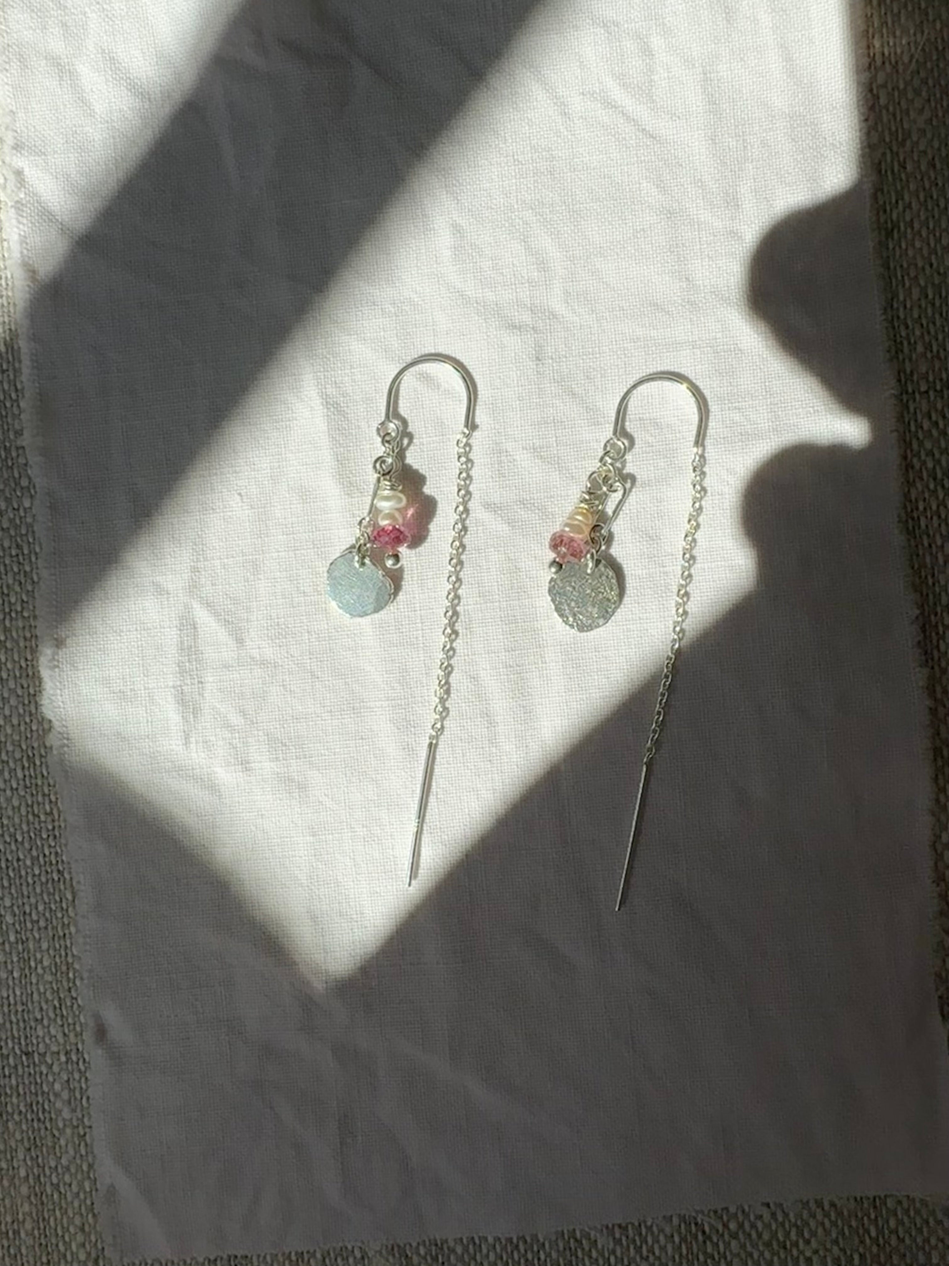 pearl and rhodolite beads with hand forged sterling silver charms on sterling silver ear threaders