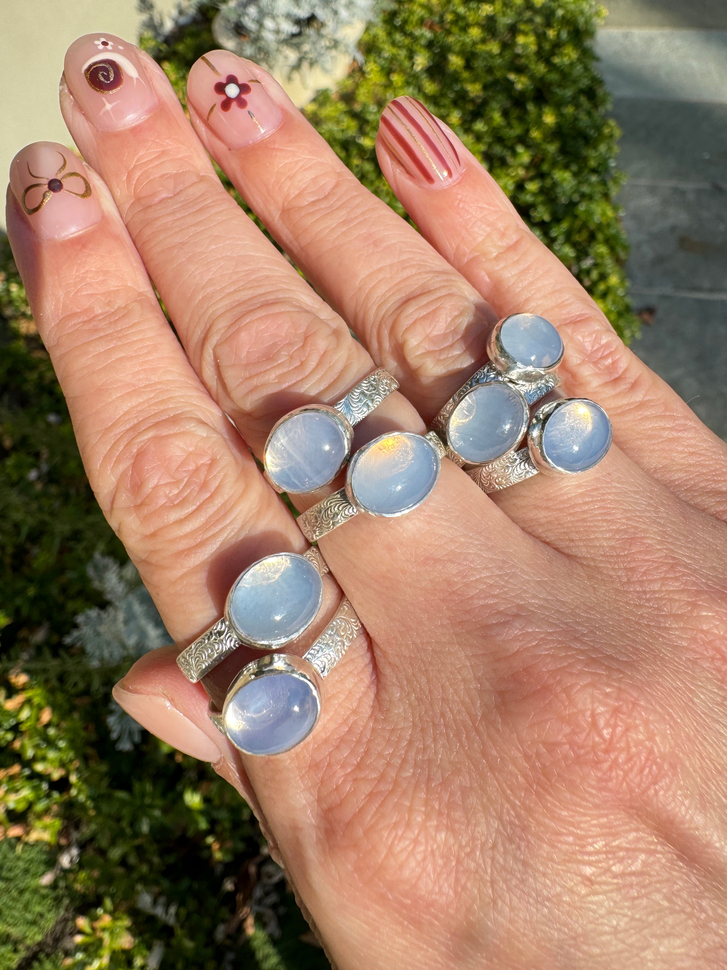 Sparkling lavender moon quartz on shiny sterling silver patterned bands