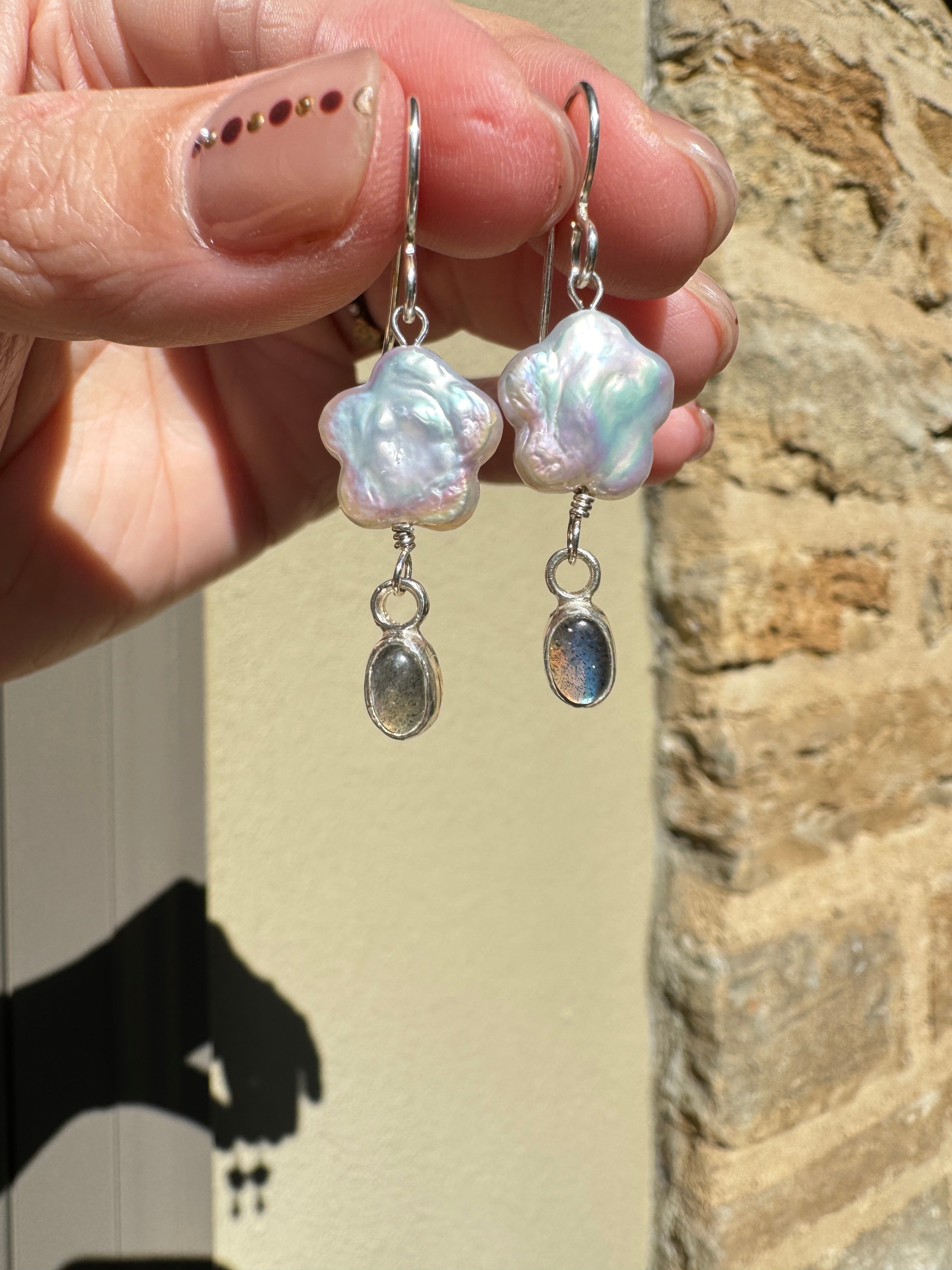 Freshwater flower shaped pearls with 4x6mm icy blue labradorite set in a fine silver bezel on a sterling silver back.