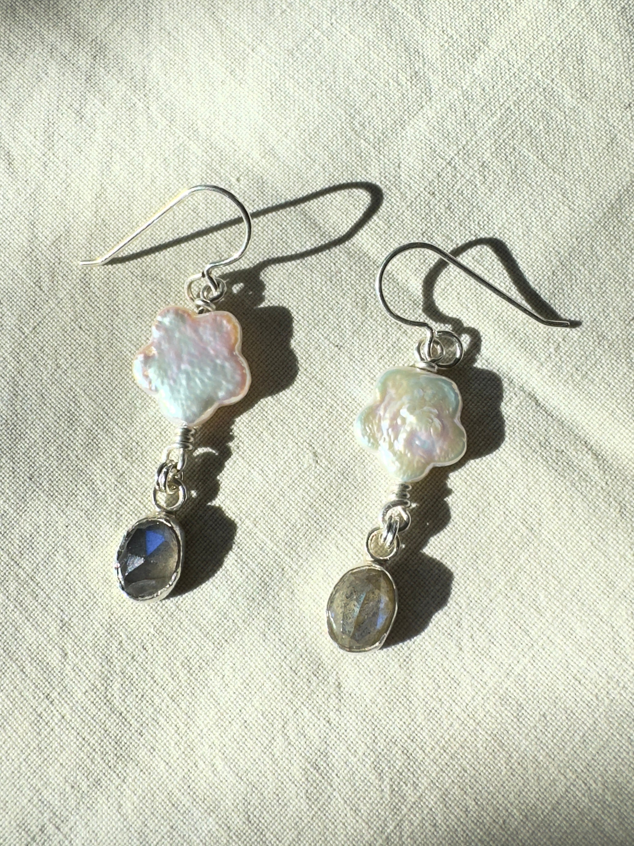 Freshwater flower shaped pearls with icy blue labradorite set in a fine silver bezel on a sterling silver back. 