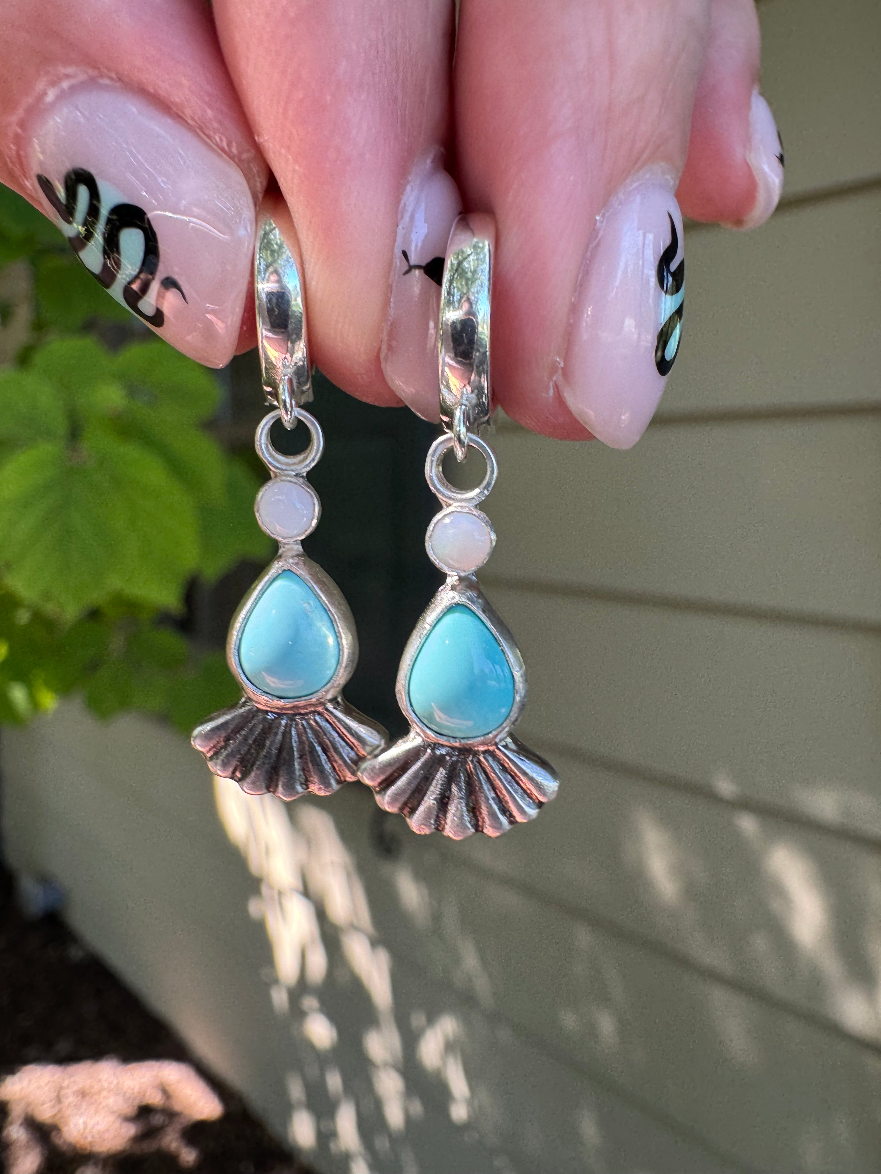 Sterling silver huggie hoops with turquoise, opal, and a sterling silver fan accent