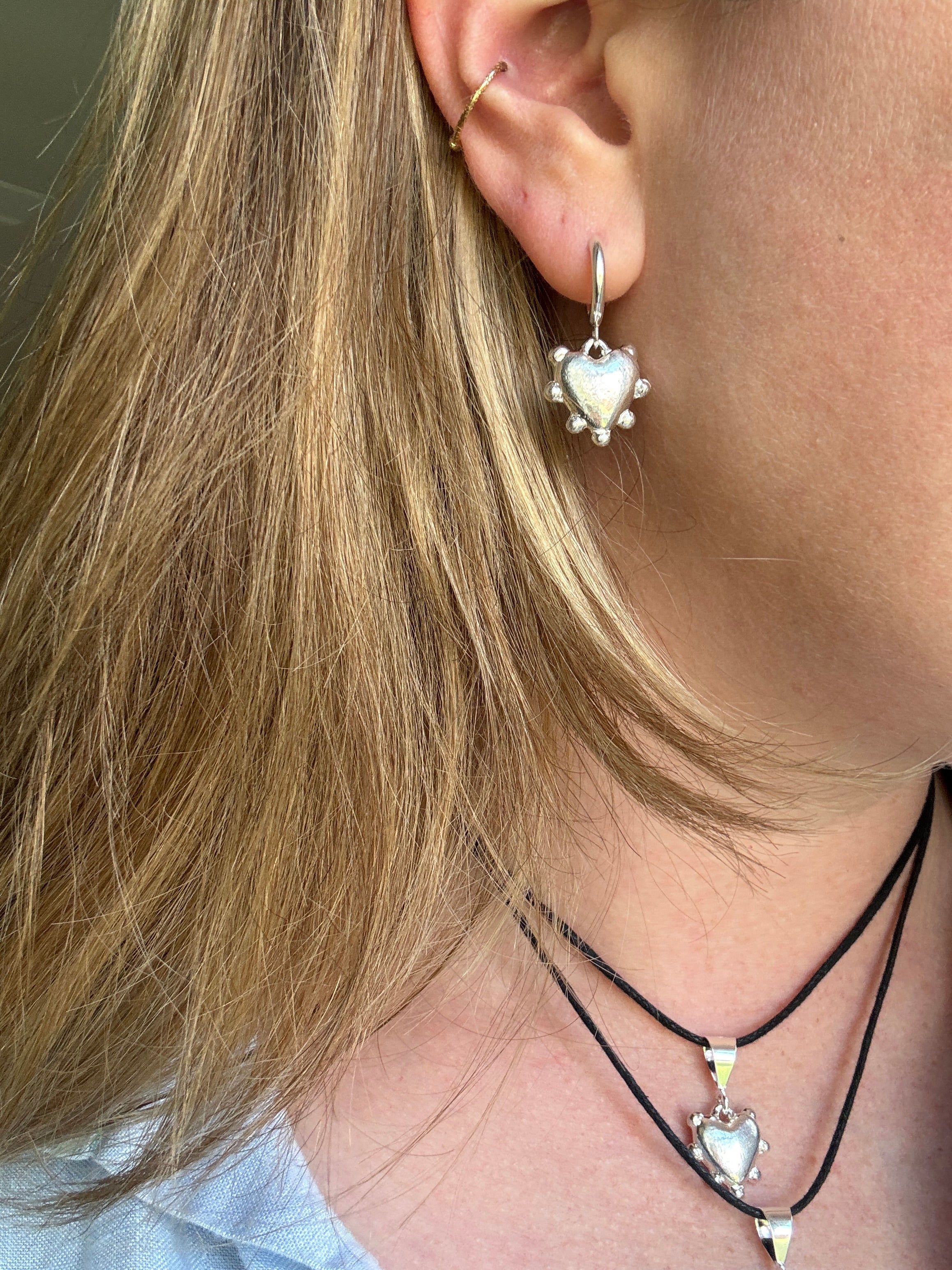 Thick sterling silver hearts bordered with dots. These are castings from an original mold that I created out of wax. These are solid silver but still light enough to wear as everyday earrings. The hoops are sterling silver as well.