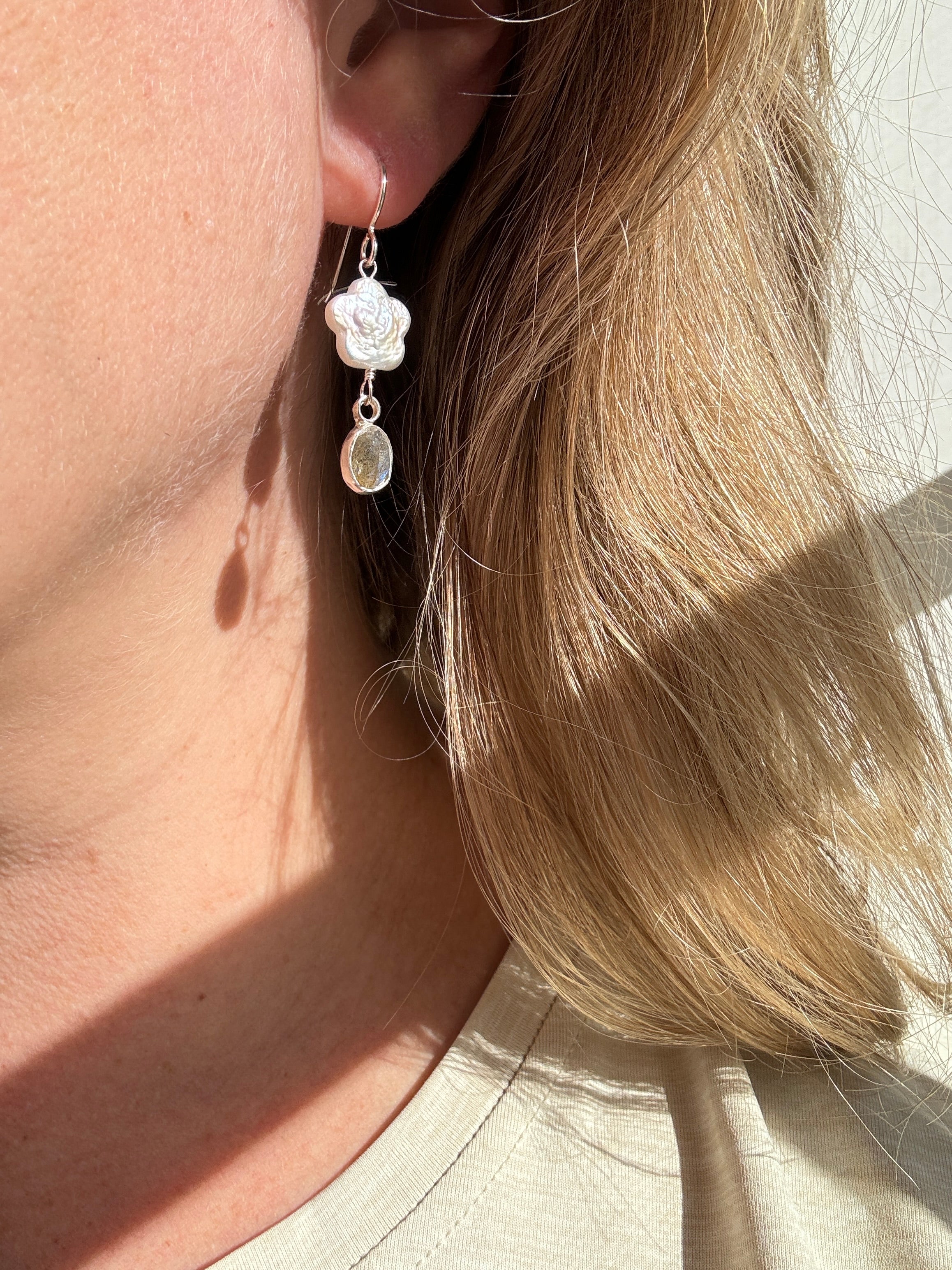 Freshwater flower shaped pearls with icy blue labradorite set in a fine silver bezel on a sterling silver back. 