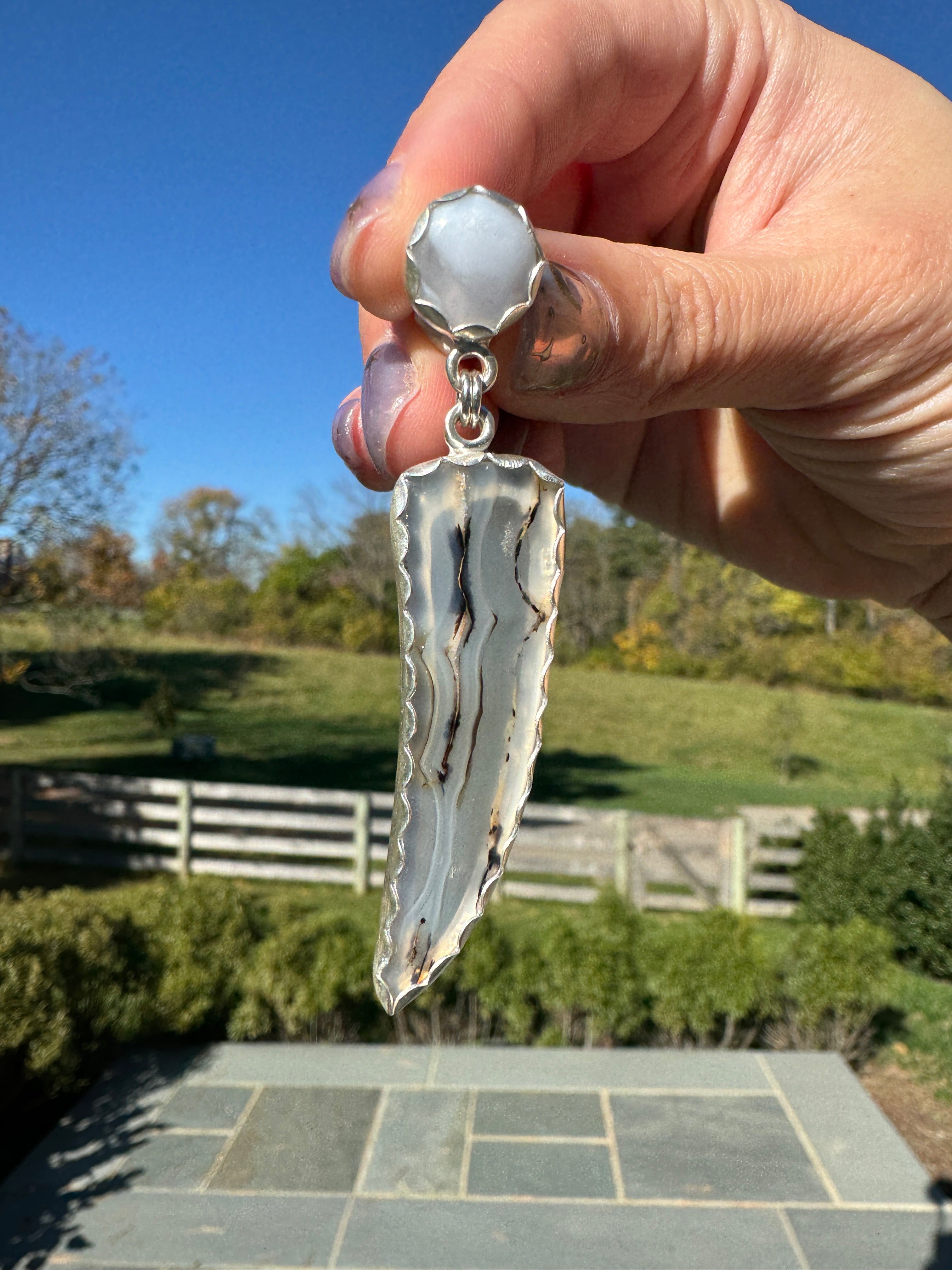 Gorgeous Montana Yellowstone Agate wrapped in fine silver and dangling from periwinkle chalcedony studs. This Montana agate was dug and cut by a Montana born female miner, making this pair extra special. These look stunning on, especially when the light hits the agate because I cut out most of the silver in the back to allow light to shine through and also keep these very lightweight and easy to wear. One of a kind pair.