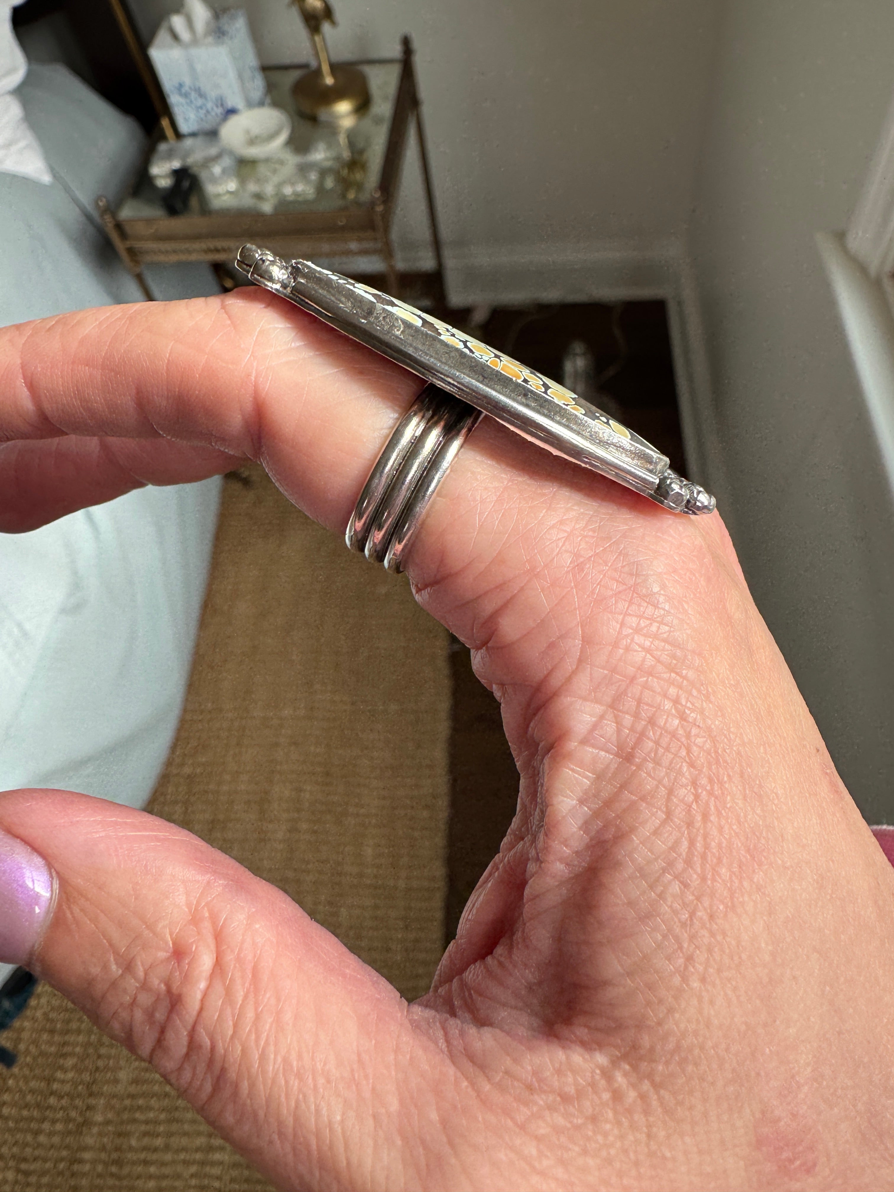 Turquoise statement ring showing a sterling silver triple wire band