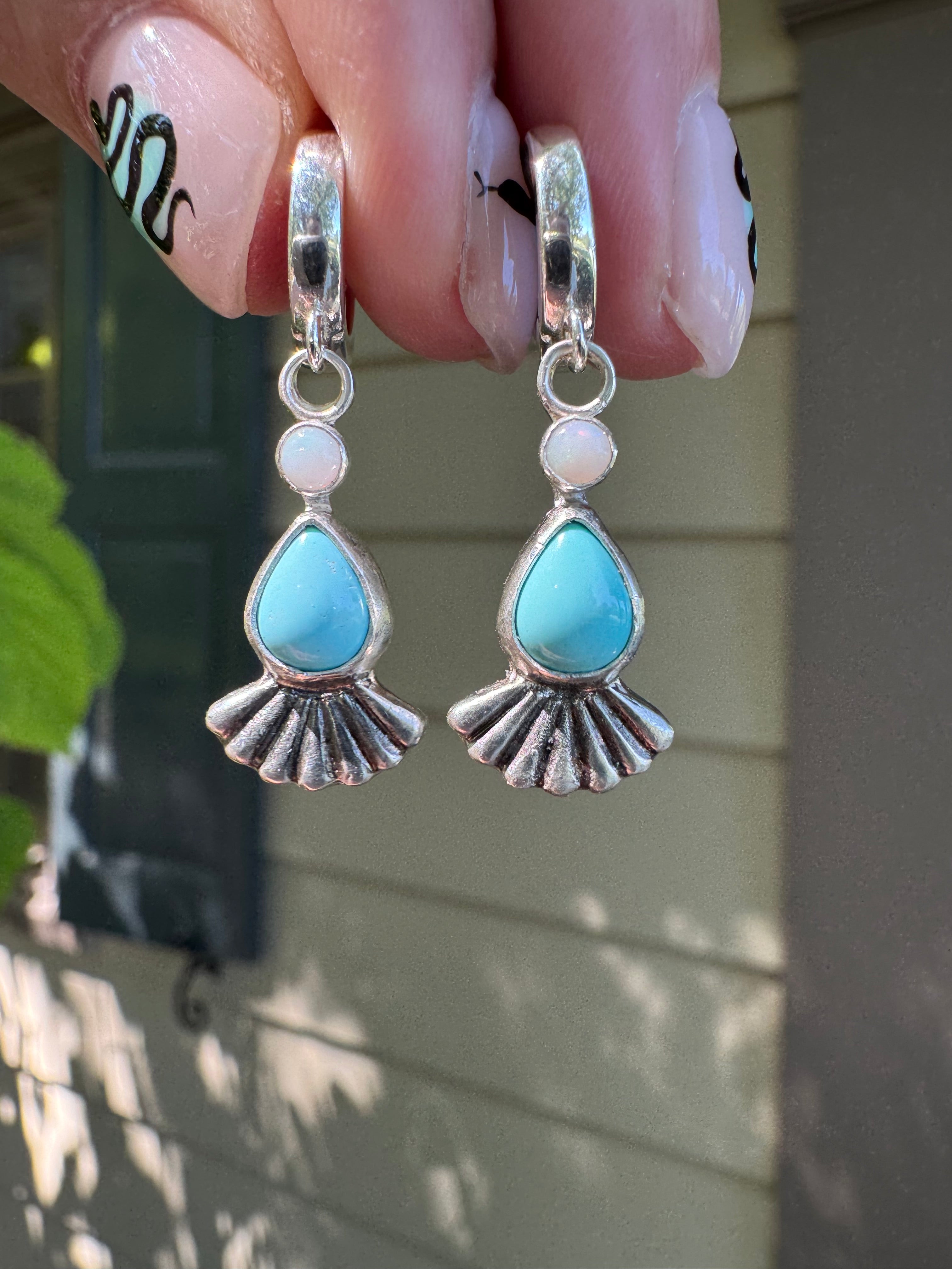 Sterling silver huggie hoops with turquoise, opal, and a sterling silver fan accent