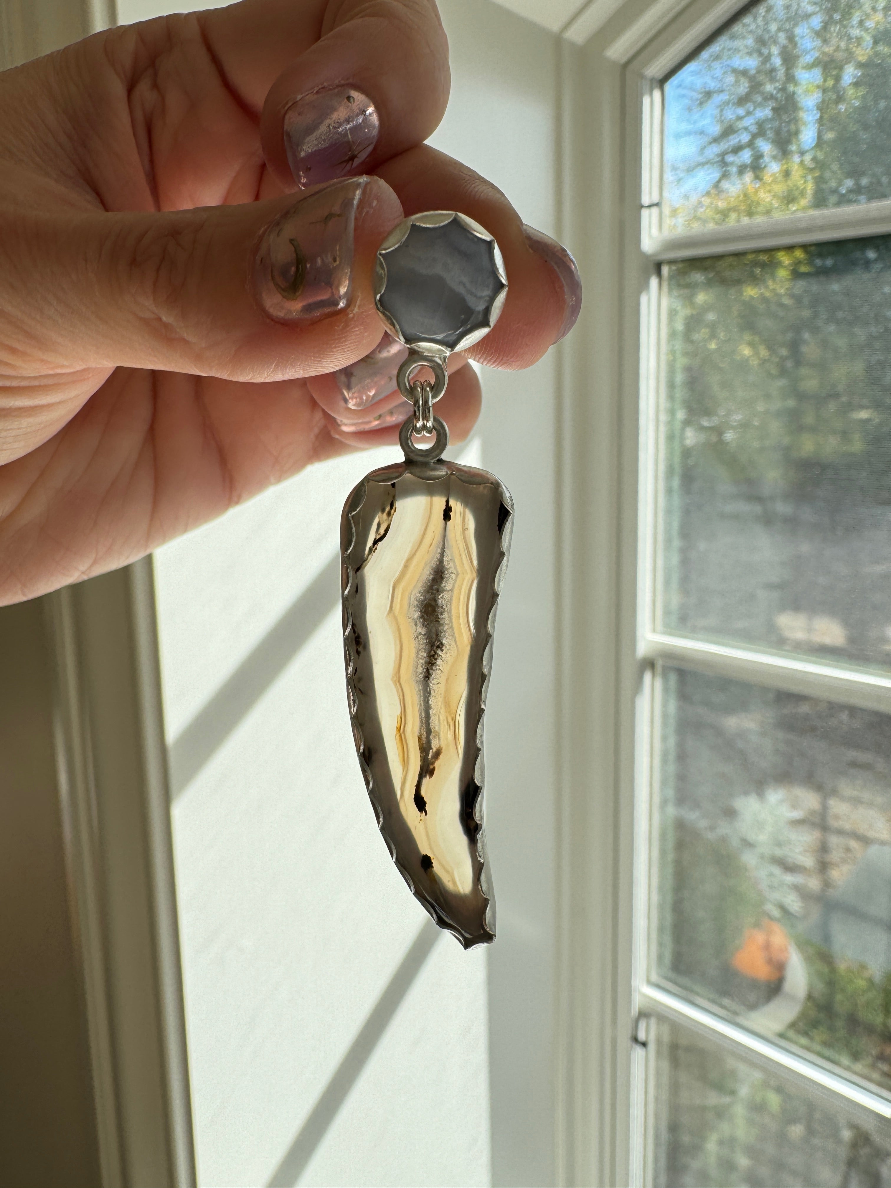 Gorgeous Montana Yellowstone Agate wrapped in fine silver and dangling from periwinkle chalcedony studs. This Montana agate was dug and cut by a Montana born female miner, making this pair extra special. These look stunning on, especially when the light hits the agate because I cut out most of the silver in the back to allow light to shine through and also keep these very lightweight and easy to wear. One of a kind pair.